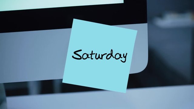 Saturday. Days of the week. The inscription on the sticker on the monitor. Message. Motivation. Reminder. Handwritten text written with a marker. Color sticker. A message for an employee, a colleague