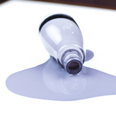 A jar of spilled varnish gray-purple color on a white background.