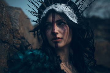 Portrait of young woman in the image of a fairy and a sorceress.