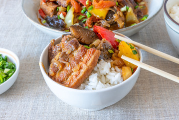 Bowl of rice with spicy pork and vegetables - a traditional Asian dish