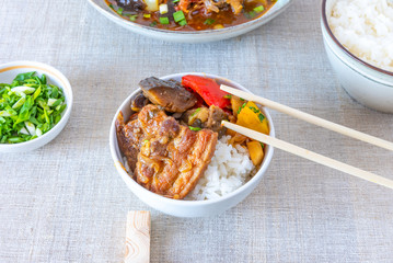 Bowl of rice with spicy pork and vegetables - a traditional Asian dish