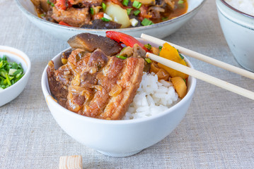 Bowl of rice with spicy pork and vegetables - a traditional Asian dish