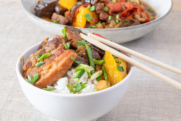 A bowl of rice with pork, eggplant and sweet pepper - a traditional Japanese dish