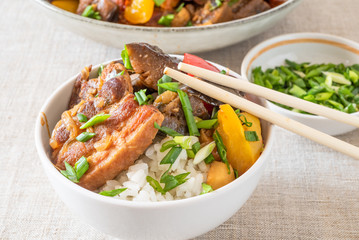 A bowl of rice with pork, eggplant and sweet pepper - a traditional Japanese dish