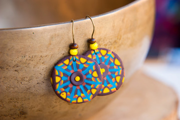 Bright african tribal earrings. Handmade jewelry background in boho style.