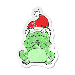 retro distressed sticker of a cartoon frog in christmas hat