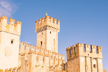 Castle in the north of Italy near the lake. Ancient castle and blue sky. Travel in Europe and tourism. Free space for text.