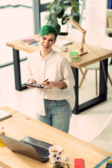 Delighted happy woman using a digital device