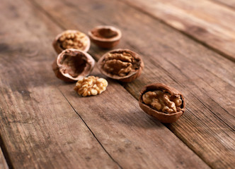 Fototapeta na wymiar walnuts on a rustic wooden table - close up