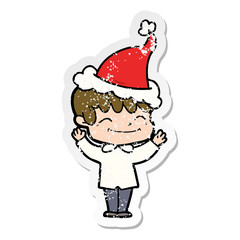 distressed sticker cartoon of a happy boy wearing santa hat
