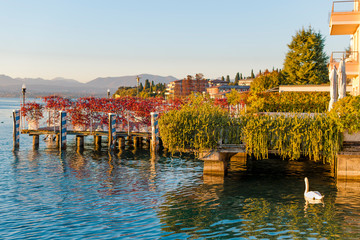 Evening sky and sunlight on the lake, a beautiful promenade with villages and the horizon with...