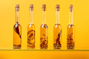 Bottles of olive oil with herbs and spices.