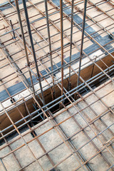 close up view of reinforcement of concrete with metal rods connected by wire. Preparation for pouring the Foundation