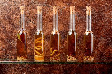 Bottles of olive oil with herbs and spices.