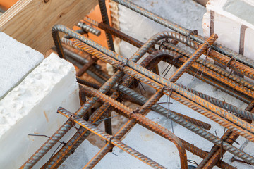 view of reinforcement of concrete with metal rods connected by wire. Preparation for pouring the Foundation