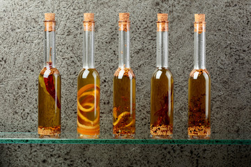 Bottles of olive oil with herbs and spices.