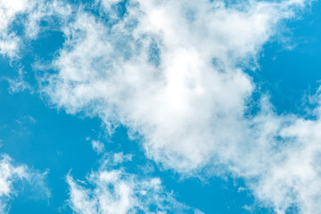 Obraz premium Teal blue sky with white clouds, an abstract background with copy space