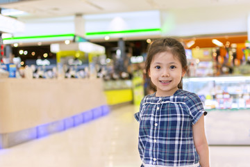 Cute Little Asian Girl in Shopping Center.