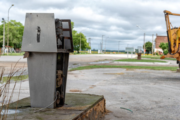 Old dirty gas station, rusted, old and abandoned gas dispenser with a landscape of a death town. The end of fossil energy