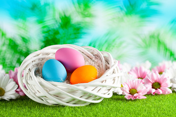 Three Easter eggs in the nest and nature background