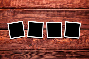 Classic photo frames on wooden board