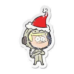 happy astronaut distressed sticker cartoon of a wearing santa hat