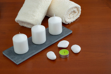 Fototapeta na wymiar towels candles stones and orchid