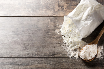 Flour bag on wooden table. Copyspace