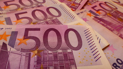 Close-up view from the frontside of multiple 500 Euro banknotes