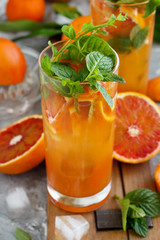 Homemade refreshing drink with bloody orange juice and mint