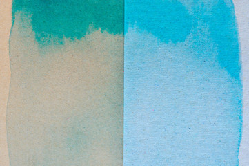 Blue and green watercolor on brown paper background