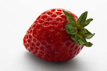Large red strawberry on a white background