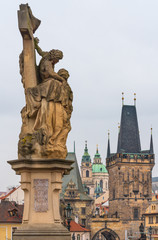 Fototapeta na wymiar Prague, Czech Republic. The statue of St. Lutgardis is an outdoor sculpture of the Charles Bridge. Plate enscripted on the statue in Latin words 