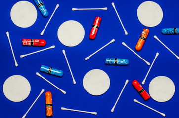 Concept of the menstrual period. Women's Protection of Hygiene. Multicolored flower swabs with colorful petals on a blue background