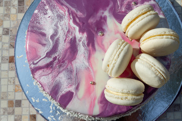 cake with mirror icing and macaroons