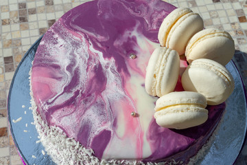 cake with mirror icing and macaroons