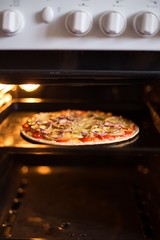 Pizza baking in the oven (close)