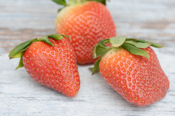 Strawberries lying on wood