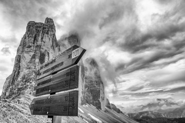 Three Peaks of Lavaredo with road signs in summer season, Italian Alps