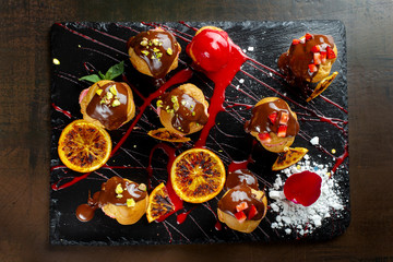 Traditional french eclairs with chocolate and nuts.