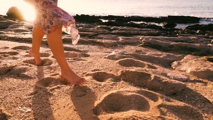 Young girl running barefoot at the sunny beach