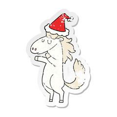 distressed sticker cartoon of a horse wearing santa hat