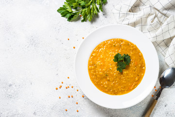 Red lentil soup on white top view.