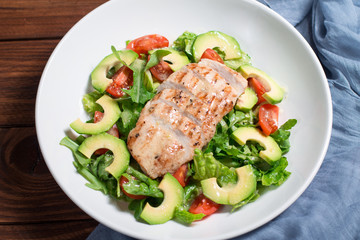 Mix salad with grilled chicken, avocado, tomatoes