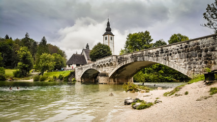 Church and bridge on Bohinj lake in Slovenia near the Triglav mountain adn part of Triglav national pak