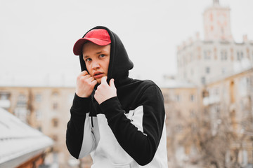 stylish man in the hood in urban city, modern fashion clothes concept f