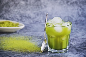 Iced matcha tea isolated on grey background. Refreshing iced green tea 