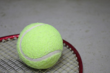 Tennis ball on racket.