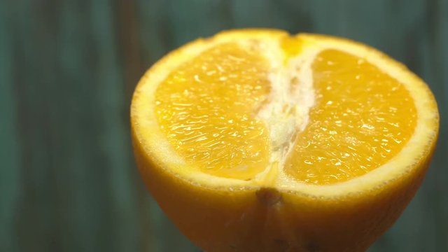 half orange 360 degree torning on a wooden background, tasty healthy food