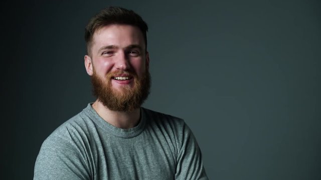 Young bearded hipster man laughing talking